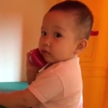 Baby "talking" on the phone will brighten your day!