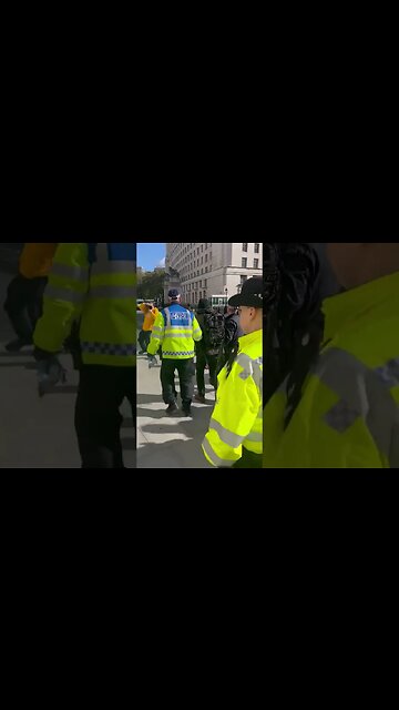 A man is taken away by British police for carrying a Union Jack flag