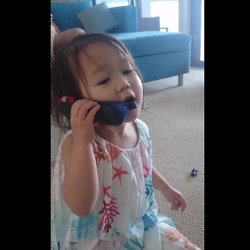 Toddler on "cell phone" is deep in conversation