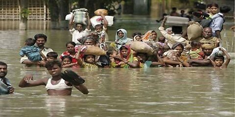 Flood situation, houses, shops and people submerged in water, bike car also washed away