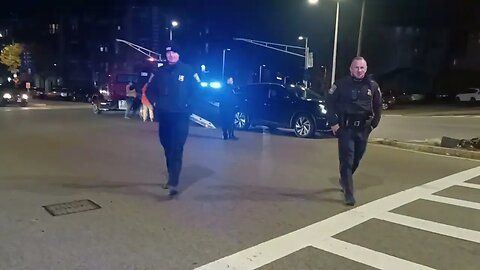 Boston police directing traffic after car takes out light Pole.