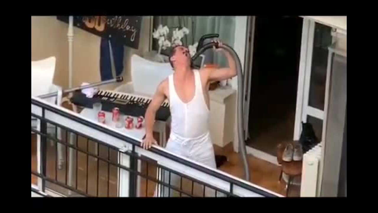 Freddie Mercury impersonator performs 'We Are The Champions' from his balcony