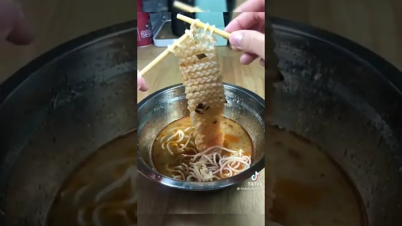 Woman knitting a scarf with noodles