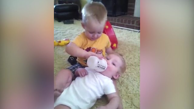 Tot Boy Loves To Bottle Feed His Baby Brother But Doesn’t Like Kissing Him