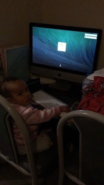 Baby learning to type on computer