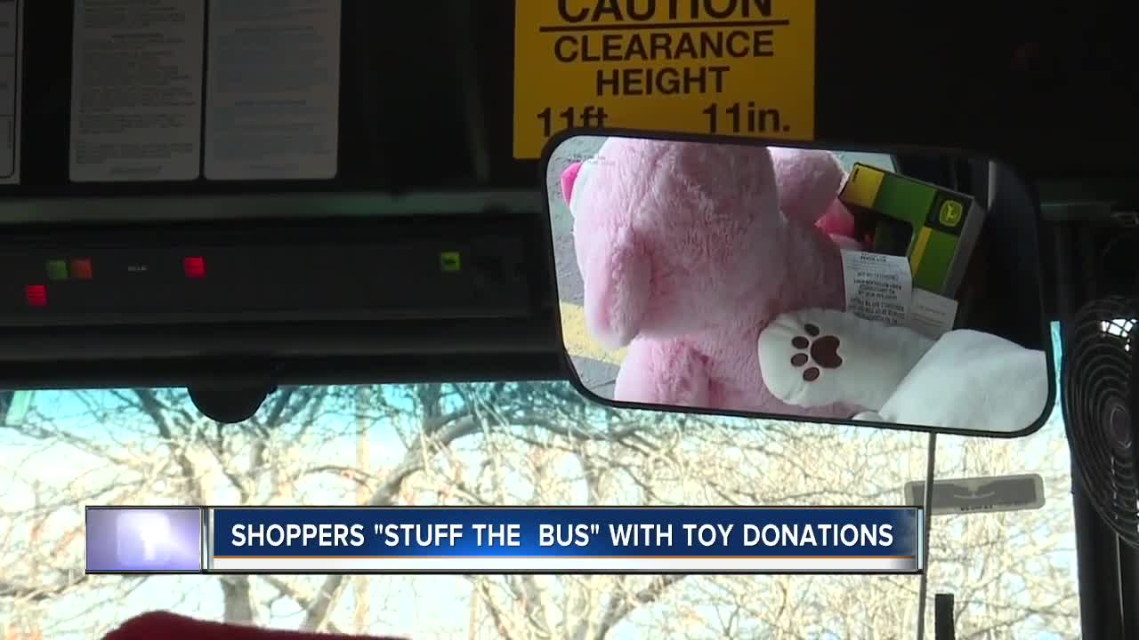 Shoppers help "stuff the bus" with holiday donations