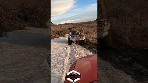 Snow wheeling LS swapped Jeep with Ursa Minor camper top and FJ Cruiser