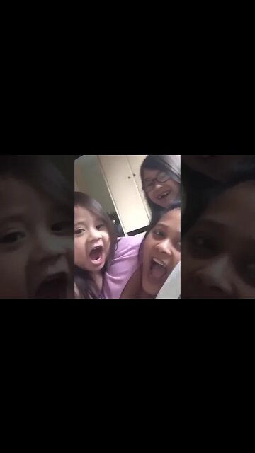 Cute mommy and her baby girls get ready for a selfie