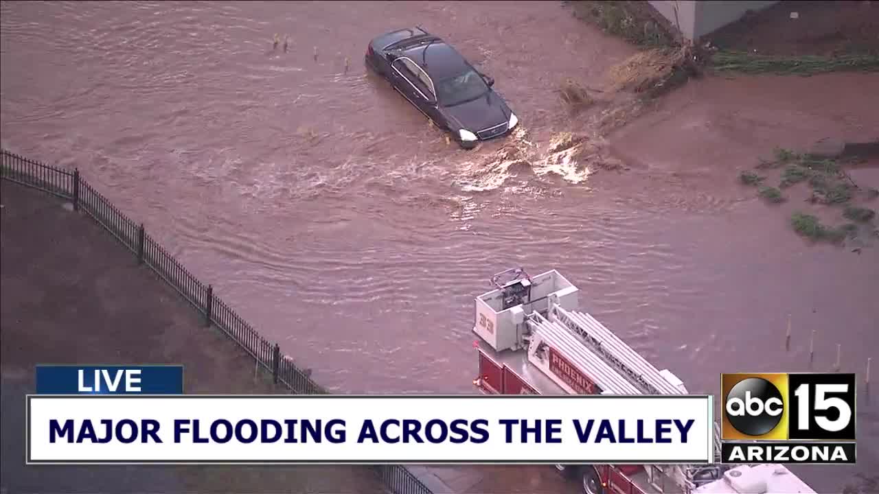 Vehicle stuck in flooded roadway in Phoenix