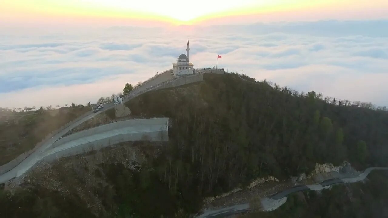 mixkit flying away from the mosque in the mountain