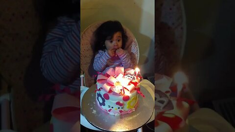 Baby girl is celebrating her second birthday by eating cake with her little hands only-super funny