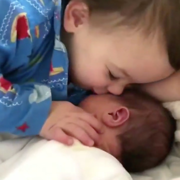 See how toddler cuddles his younger brother