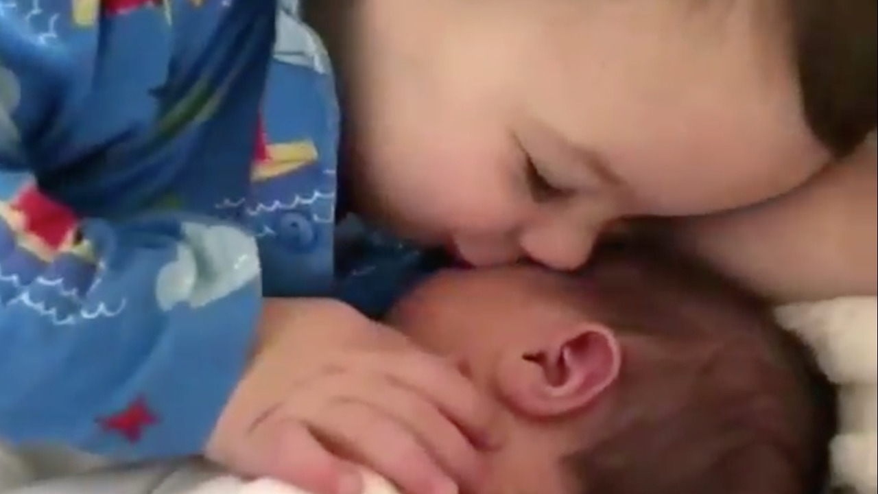 See how toddler cuddles his younger brother