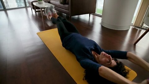 Weight Loss Slow Motion Footage OF A Woman Exercising On A Yoga Mat In The Living Room Floor