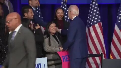 Biden rubs a woman's face and doesn't let go of her hand