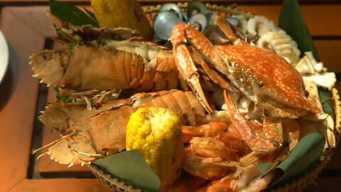 Dish with seafood rotate on wooden table in restaurant