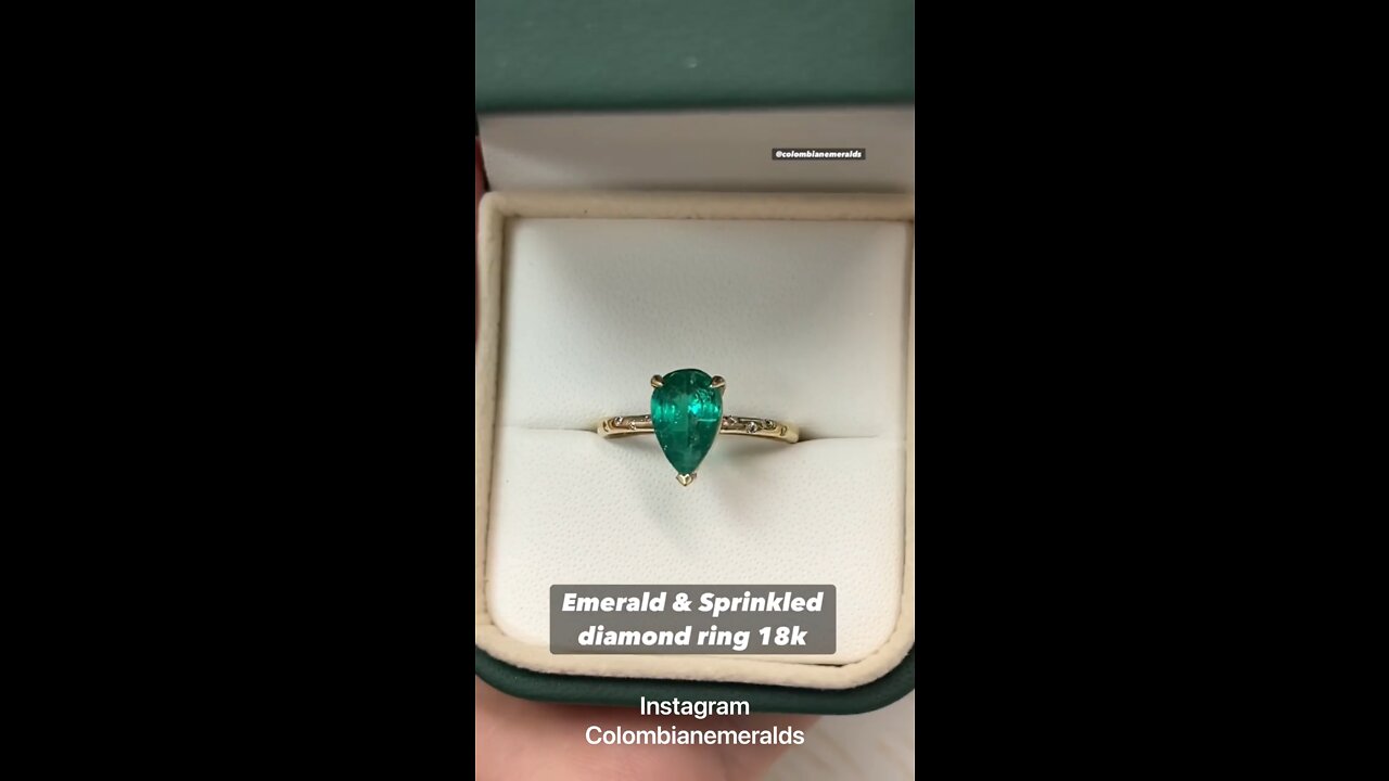 Dark green Colombian emerald pear and sprinkled diamond solitaire with accent ring in 18K gift