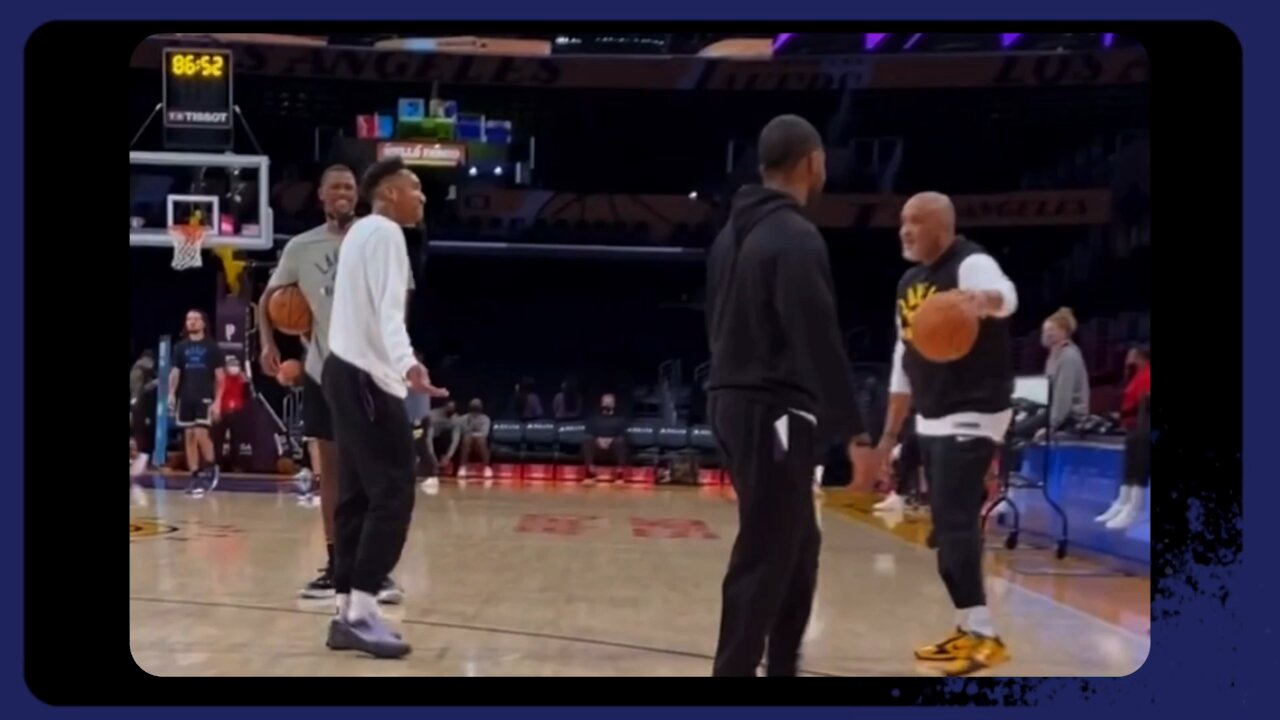 Trevor Ariza , Austin Reaves and Bazemore as Lakers GM Rob Pelinka looks on sitting courtside