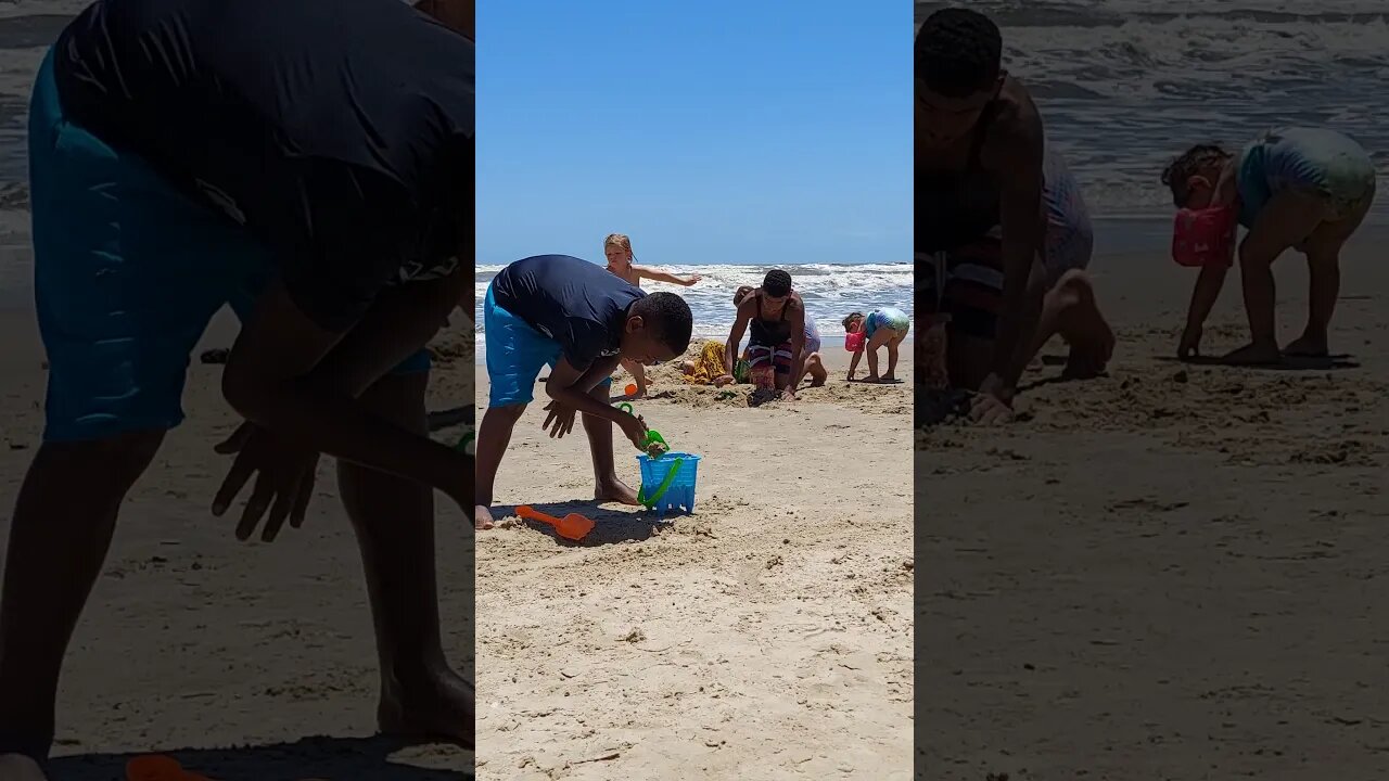 Kids bury Patrick in the sand. Kinzlee rubs her cheese hands on him.