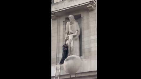 Someone has climbed onto the BBC building and smashing up the Eric Gill pedo statue