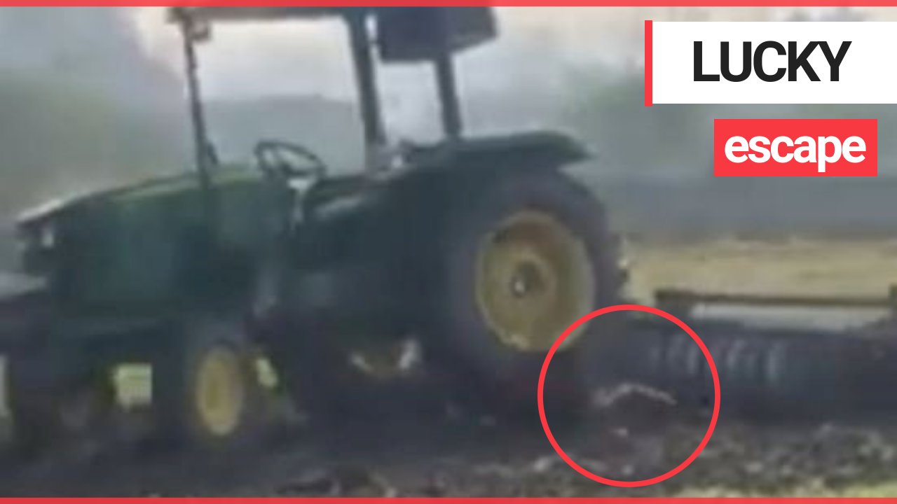 Young farmer tries to leap on a moving tractor - but is dragged beneath the wheels