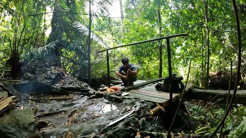 Building a bamboo shelter on a rock face:13