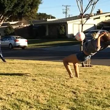 A Girl Flips Into A Soccer Ball To Her Face