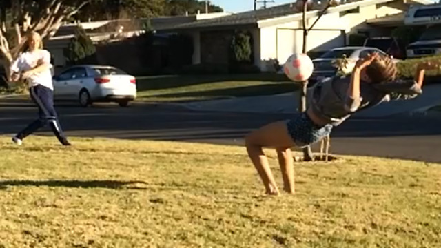 A Girl Flips Into A Soccer Ball To Her Face