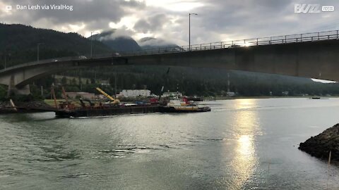 Crane hits low bridge in Alaska