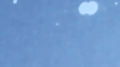 UFO flies under jet into space