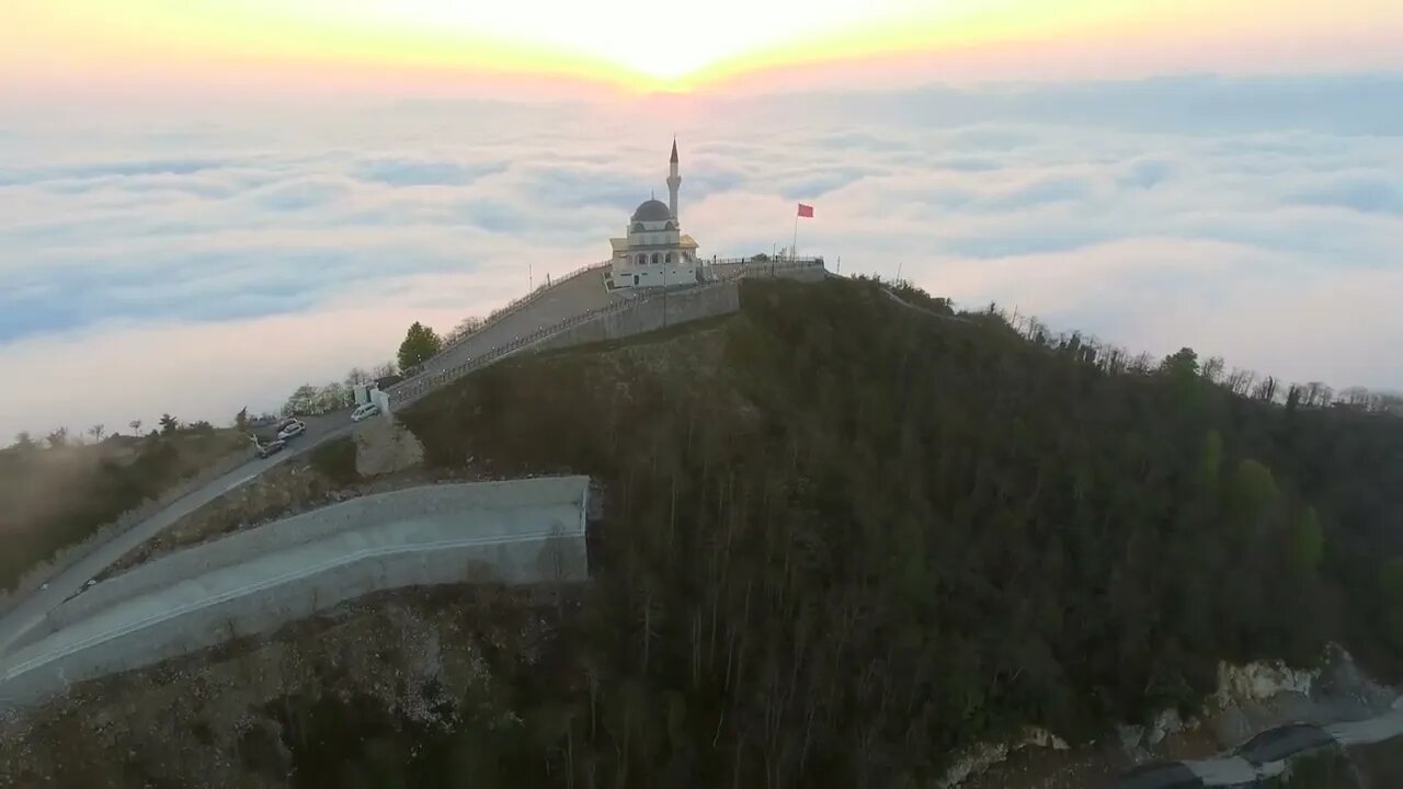 mixkit flying away from the mosque in the mountain