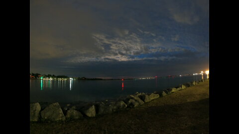Setting up the lighting for a night riverside vlog