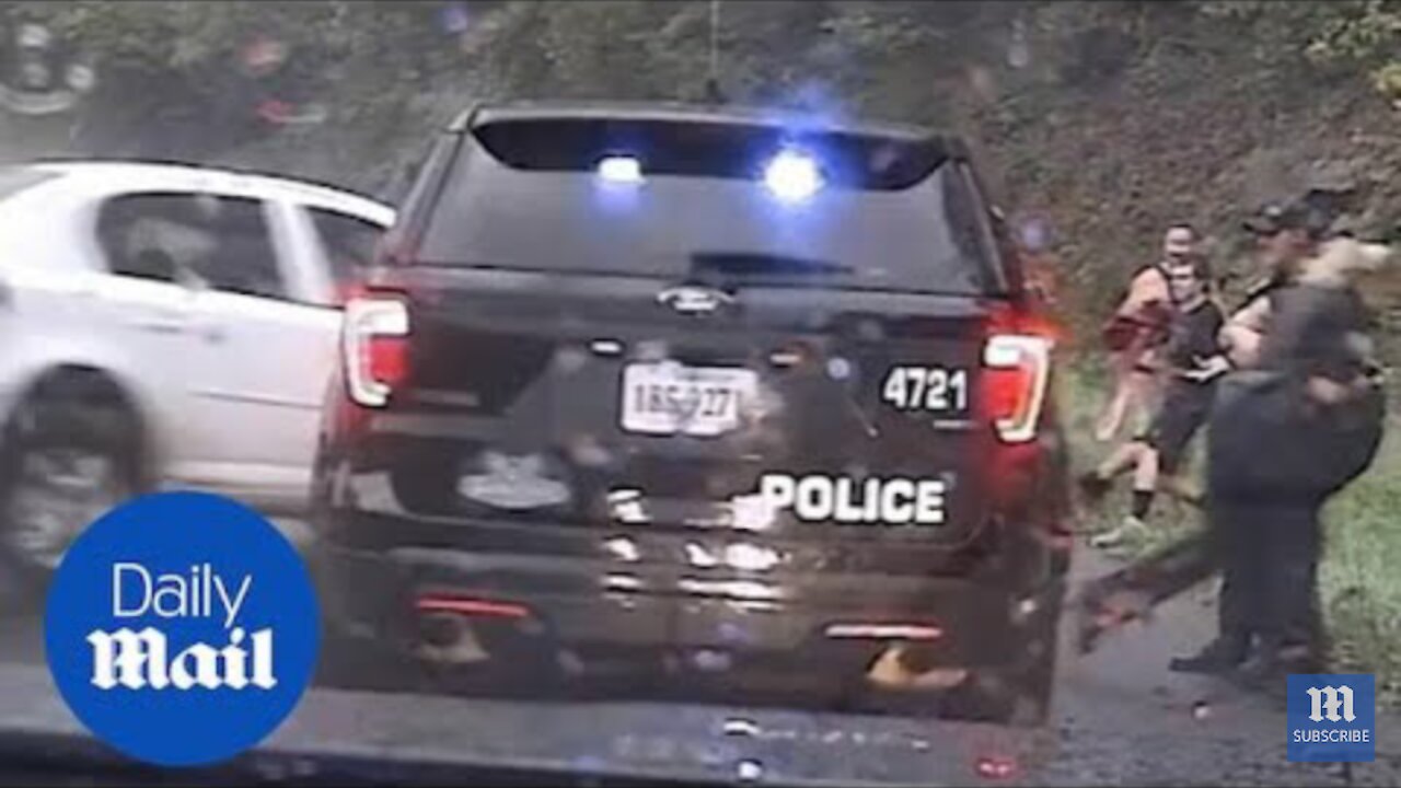 Shocking moment cop saves colleague from skidding car