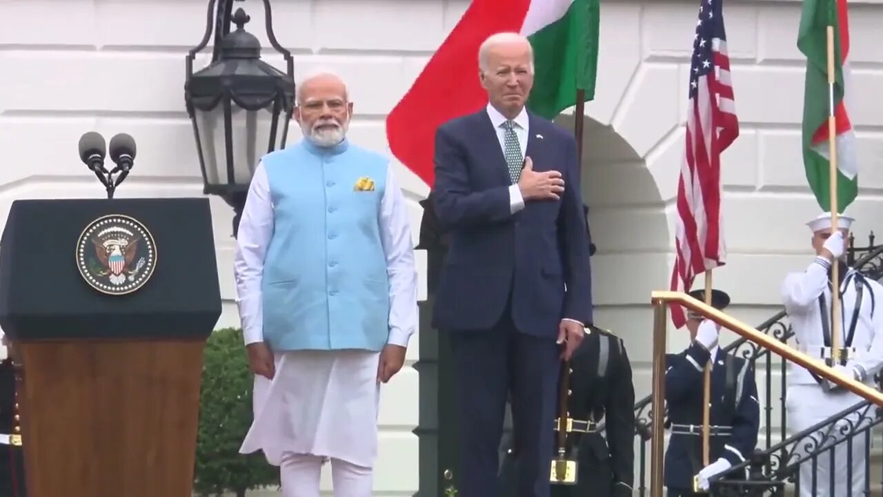 Joe Biden slowly lowers his hand from heart after realizing they're playing Indian national anthem.