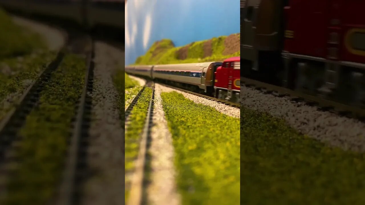 N scale F units pulling a passenger train over the pass