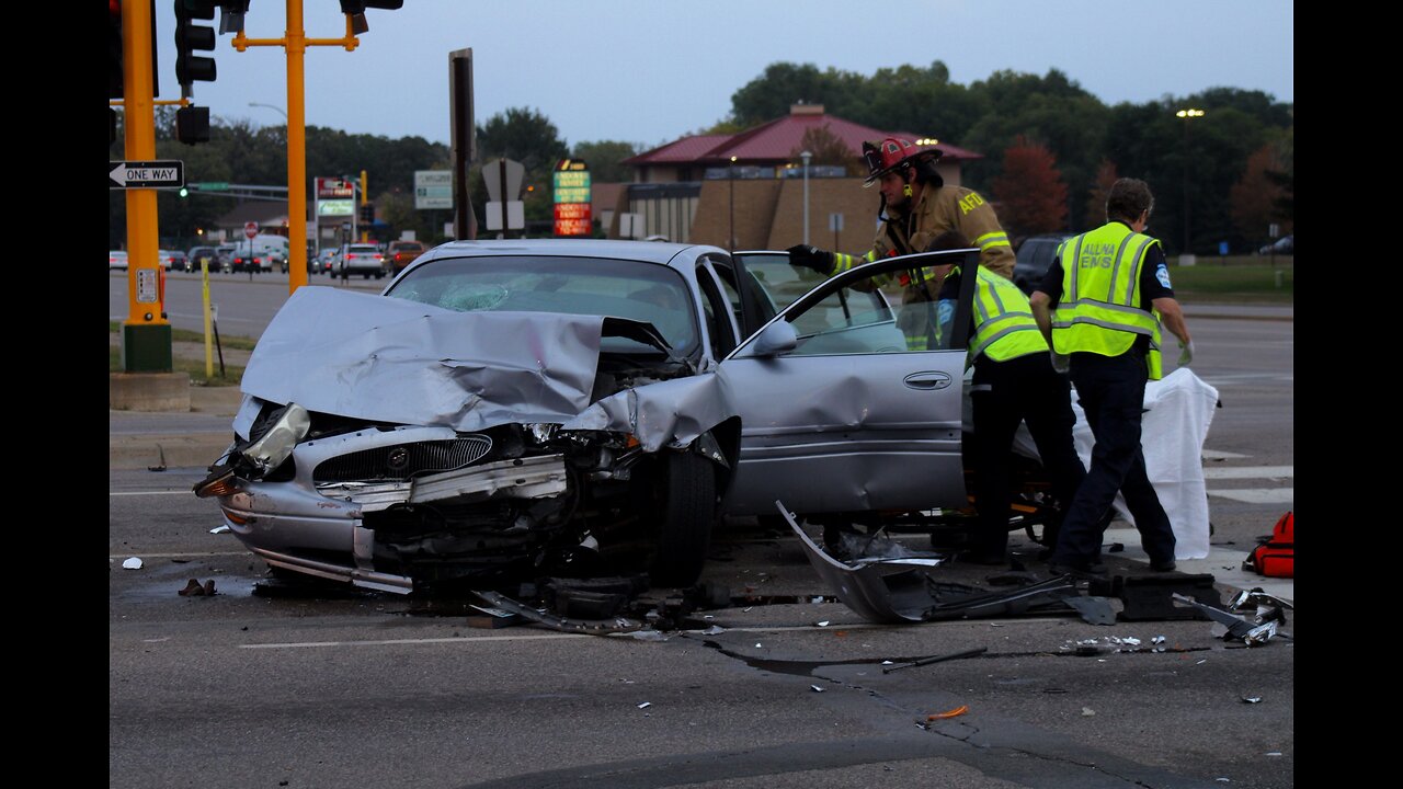 Red Light Runner aftermath with Police, Fire Department and EMS at Car Crash