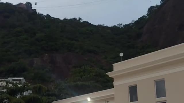 Person Practices Slackline on Mountain