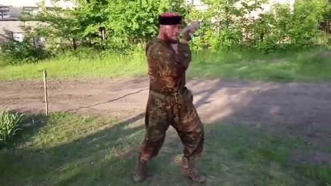 A Russian soldier with the call sign "Rambo" demonstrates his "skills"