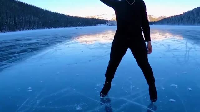 elladjbalde creates art as he skates on Lake Louise in Banff National Park