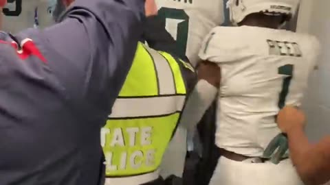 Michigan, Michigan State players fight in postgame tunnel.