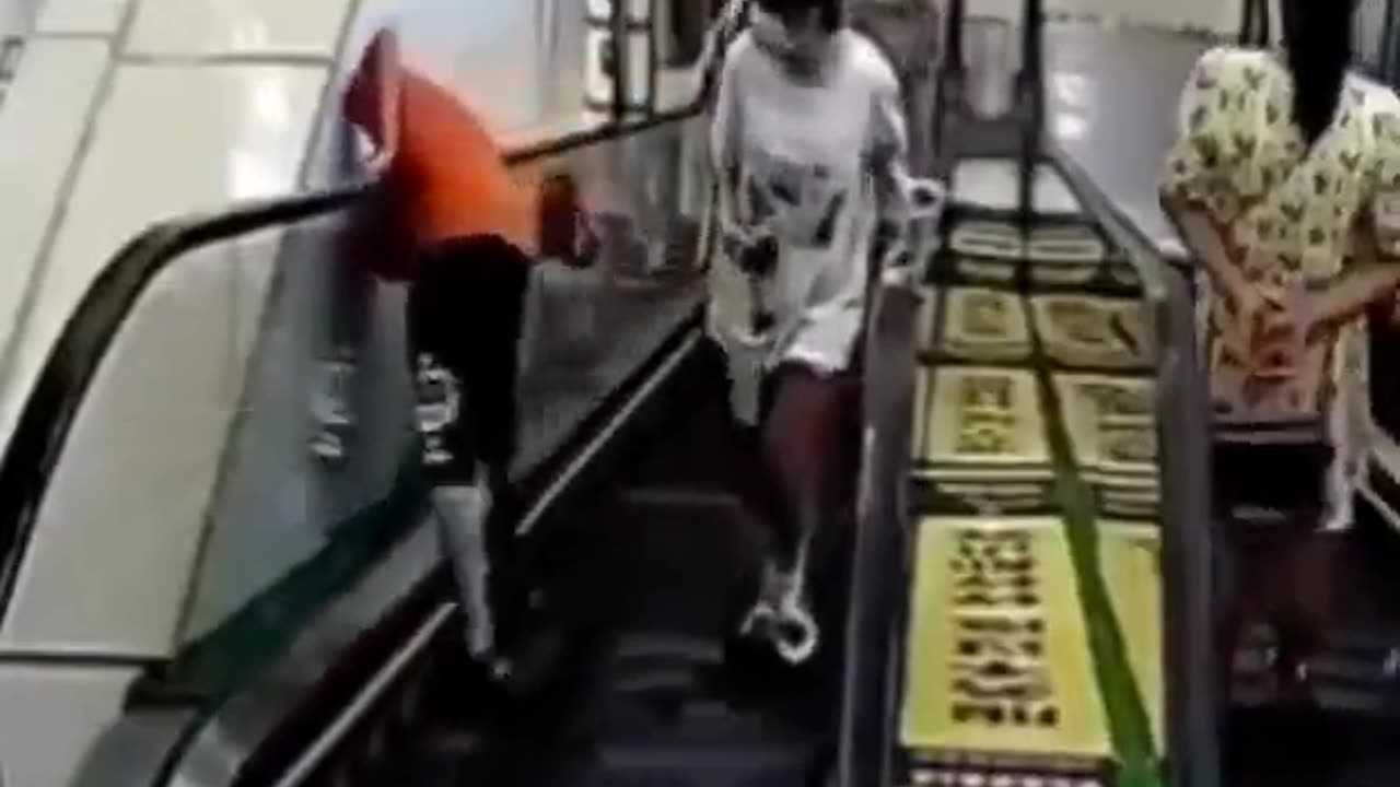 Boy gets stuck between escalator and wall