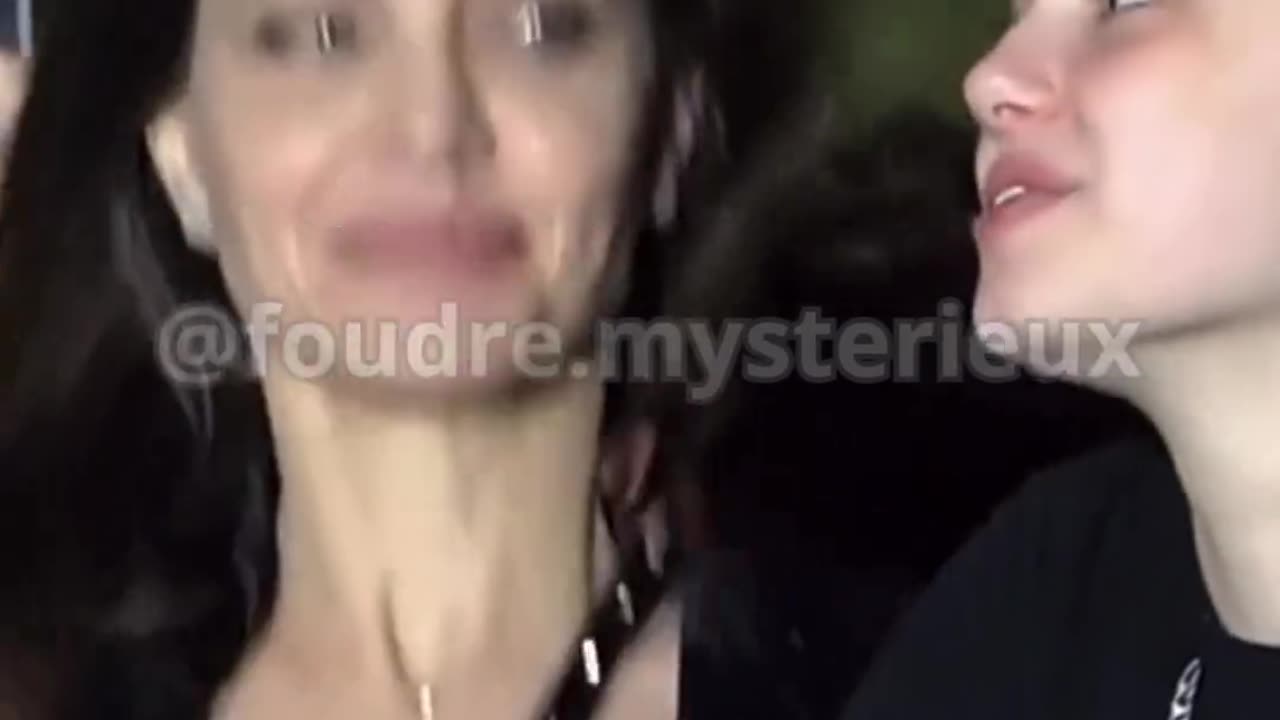 What is she holding in his hand?