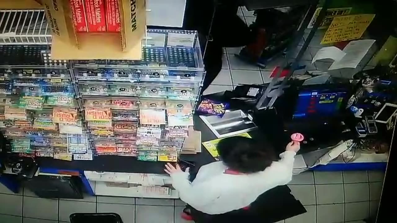 Cashier girl is using mobile phone while dealing with the customer