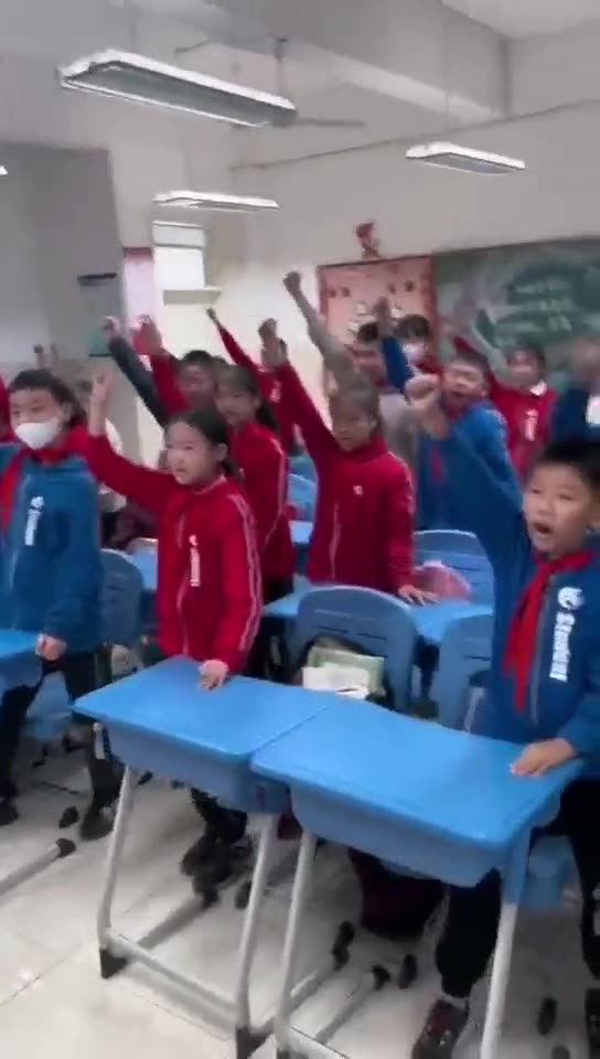 Chinese schoolchildren in classroom shout in unison: we will destroy the enemy!