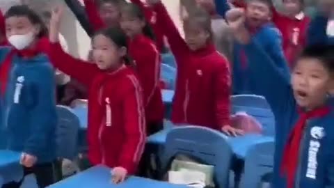 Chinese schoolchildren in classroom shout in unison: we will destroy the enemy!