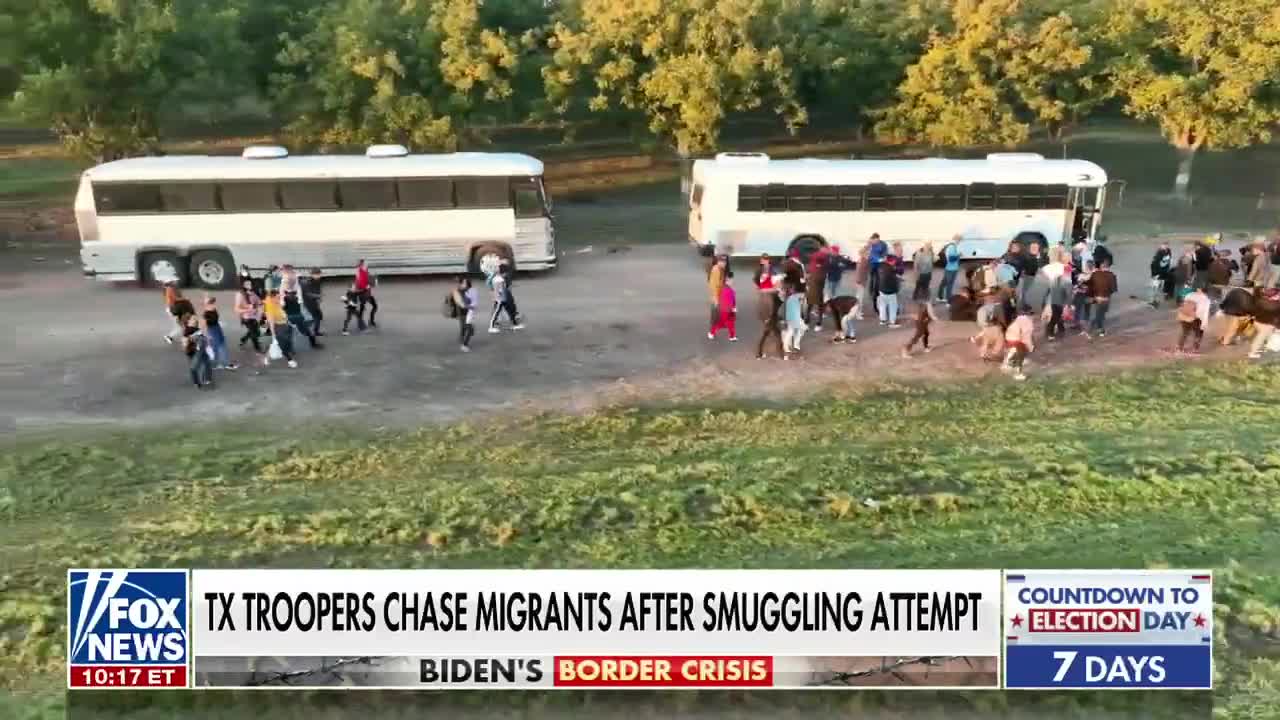Migrants wave flag on US soil after illegally crossing border