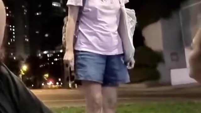 Masked woman confronts streamer, kicks food away