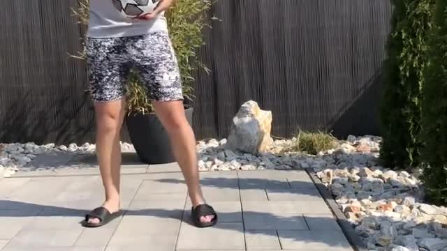 Man Performs Tricks by Bouncing Bottle off Ball and Catching It