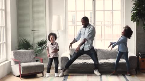 African Dad Dancing Having Fun With Kids In Living Room