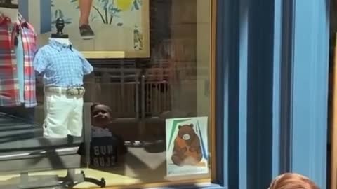 Kid With Limb Difference Reacts to His Poster in Store Window At Mall